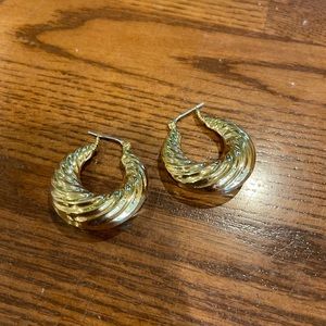 Gold hoop earrings with small ridges